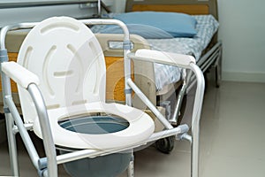 Flush toilet and shower chair in bathroom for old elder people