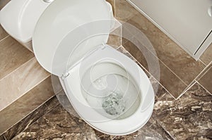 Flushing the toilet. A strong whirlpool of water in the toilet
