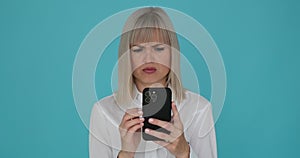 Flustered Woman Using Phone on Blue Background