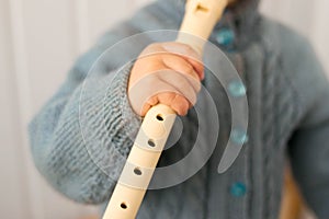 Flute. Block flute. The child plays the pipe. Music. The child is making music. Art. Musical instruments