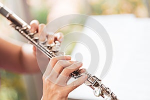 Flute :  A closeup of hands of a musician playing the flute, detail shot, classical music, wind instrument performance player up