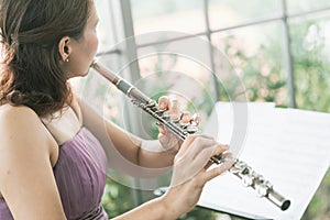 Flute :  A closeup of hands of a musician playing the flute, detail shot, classical music, wind instrument performance player up