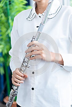 Flute :  A closeup of hands of a musician playing the flute, detail shot, classical music, wind instrument performance player up
