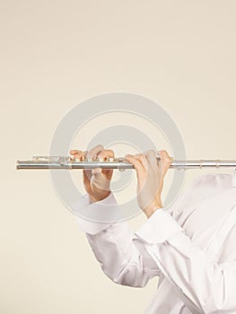 Flute music instrument in hands of flutist musician