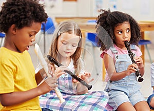 The flute is our favourite instrument. Shot of children learning about musical instruments in class.