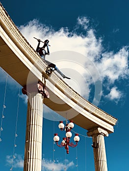 A flutist plays atop columns in the main square in Irpin - UKRAINE - MUSIC photo