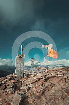 Fluttering flags on top of the mountains in summer time