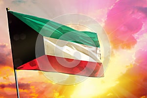 Fluttering Kuwait flag on beautiful colorful sunset or sunrise background. Success concept