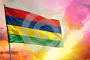 Fluttering Mauritius flag on beautiful colorful sunset or sunrise background. Success concept