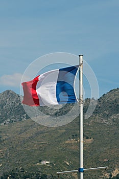Fluttering tricolor flag. Menton, France