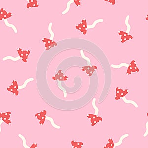 Fly agaric on a pink background seamless pattern.