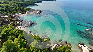 Fly along lagoon with turquoise water, sandy beach and pine trees. Beautiful orange beach Kavourotripes , Sitonia