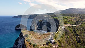 Fly around cliff and rocks over ocean along coast