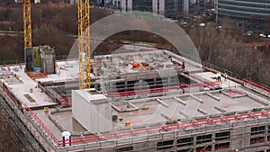 Fly around commercial object under construction. Construction site of multistorey building. Frankfurt am Main, Germany