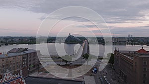 Fly around historic buildings in old town. Revealing Daugava river waterfront and Akmens tilts bridge. Modern design