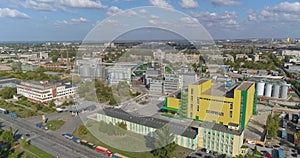 Fly around a modern factory. Large modern yellow plant aerial view. Modern plant in a yellow exterior