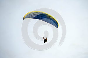 Fly on the blue sky by parachuting.