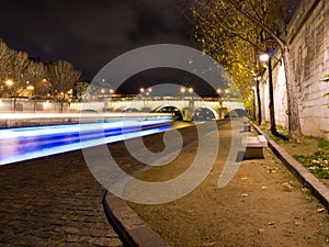 Fly-boat cruising on the river Seine by night.