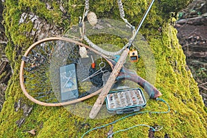 Fly box and fishing tackle on the river bank