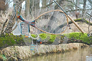 Fly box and fishing tackle on the river bank