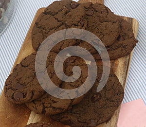 Fly on chocolate, chocolate chip cookies and breadboard