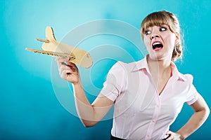 Fly fear. Woman holding airplane in hand.