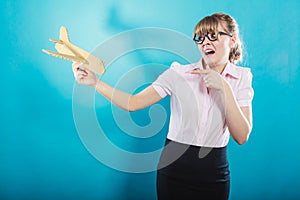 Fly fear. Woman holding airplane in hand.