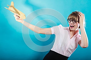 Fly fear. Woman holding airplane in hand.