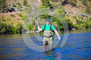 Fly Fisherman Casting on the Deschutes River