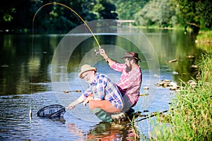 Fly fisherman fishing. fly fish hobby of men. retirement fishery. Two male friends fishing together. Catching and