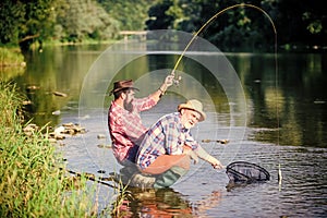 Fly fisherman fishing. fly fish hobby of men. retirement fishery. Two male friends fishing together. Catching and