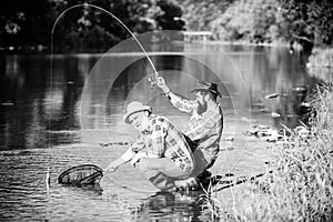 Fly fisherman fishing. fly fish hobby of men. retirement fishery. Two male friends fishing together. Catching and