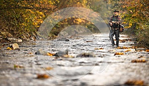 Fly fisherman  on a splendid mountain river photo