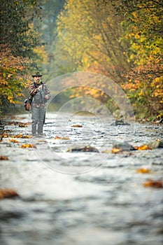 Fly fisherman fly fishing on a  mountain river