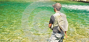 Fly fisherman flyfishing in river