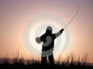 Fly fisherman silhouette