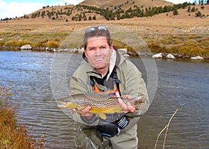 Fly fishing - fisherman holding fish