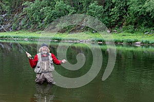 Fly fishing. Man bearded fisherman make ready angling on river