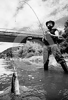 Fly fishing - method for catching trout. Fishing in river. Catches a fish. Catching a big fish with a fishing pole.