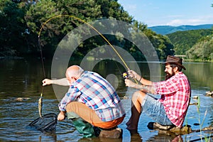 Fly fishing in the pristine wilderness of canada. Fisherman fishing in a river with a fishing rod. Generations ages