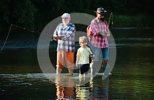 Fly fishing for trout. Senior man fishing with son and grandson. Fishing became a popular recreational activity.