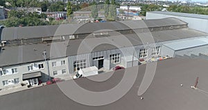 Fly over the factory in sunny weather. Modern factory. Industrial area aerial view.