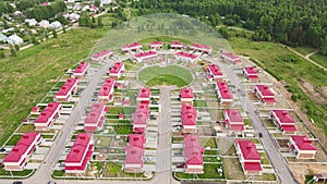 Fly over new cottages, modern townhouses in a suburban community