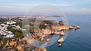 Flyaway aerial shot of Alvor village. Portimao city in the background, Portugal