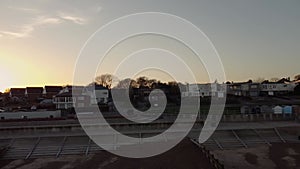 Flyaway drone footage of a shingle beach at sunset in Felixstowe, Suffolk