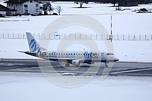 FlyBe jet taxiing in Innsbruck Airport, INN, snow