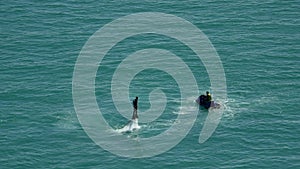 Flyboard.The silhouette of a man at sea flyboard. Sunset on sea holidays. Entertainment holiday