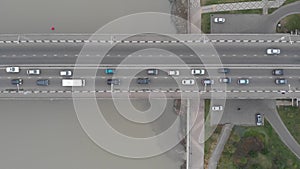 Flycam films long grey multi-lane bridge with traffic jam
