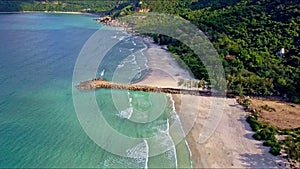 Flycam Moves from Azure Ocean to Sand Beach with Pier