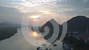 Flycam moves to amazing sunset reflection in calm river